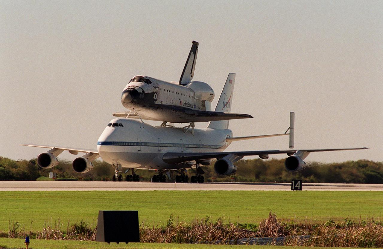 The Shuttle Carrier Aircraft with orbiter Columbia riding piggyback taxis down the runway at the KSC Shuttle Landing Facility after landing. The ferry flight began in California March 1. Unfavorable weather conditions kept it on the ground at Dyess AFB, Texas, until it could return to Florida. It landed temporarily at the CCAFS Skid Strip until Atlantis, which had already landed at the SLF, could be transferred. Columbia is returning from a 17-month-long modification and refurbishment process as part of a routine maintenance plan. The orbiter will next fly on mission STS-107, scheduled Oct. 25