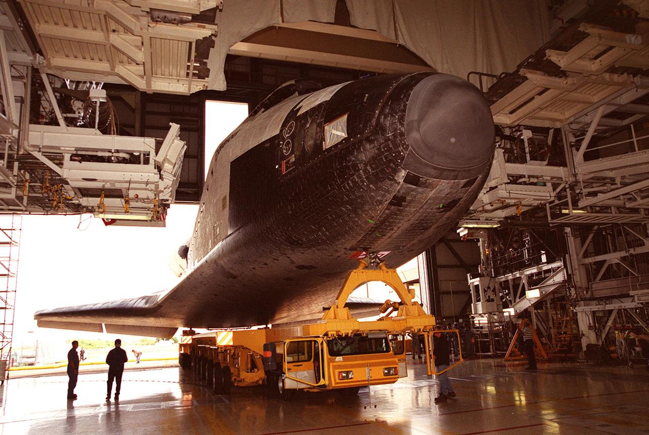 KENNEDY SPACE CENTER, FLA. -- Endeavour begins backing out of Orbiter Processing Facility bay 2 atop an orbiter transporter for rollover to the Vehicle Assembly Building. In the VAB, Endeavour will be stacked with its solid rocket boosters and external tank atop the Mobile Launcher Platform in high bay 3. Endeavour is scheduled to launch April 19 on mission STS-100, the ninth flight to the International Space Station