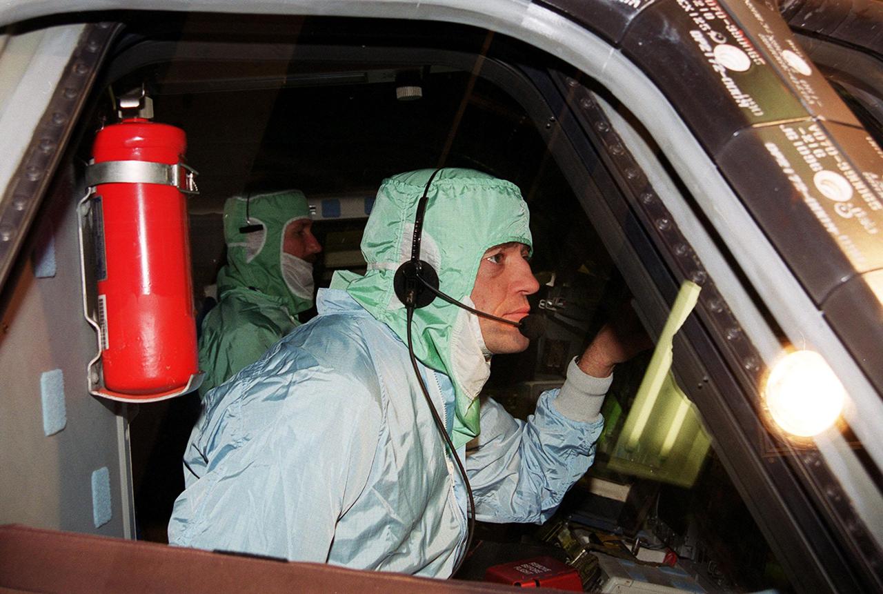 During a Crew Equipment Interface Test (CEIT) at KSC, STS-100 Pilot Jeffrey S. Ashby checks out the windshield in orbiter Endeavour. Other crew members at KSC for the CEIT are Commander Kent V. Rominger and Mission Specialists Chris Hadfield, who is with the Canadian Space Agency, Scott Parazynski, John L. Phillips, Umberto Guidoni, who is with the European Space Agency, and Yuri Lonchakov, who is with the Russian Aviation and Space Agency. The orbiter is carrying the Multi-Purpose Logistics Module Raffaello and the Canadian robotic arm, SSRMS, to the International Space Station. Raffaello carries six system racks and two storage racks for the U.S. Lab. Launch of mission STS-100 is scheduled for April 19 at 2:41 p.m. EDT from Launch Pad 39A