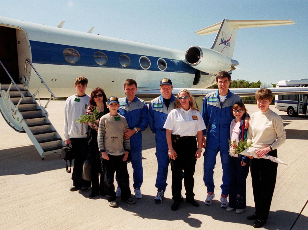 The International Space Station's Expedition One crew members and their families prepare to depart KSC from the Shuttle Landing Facility for their return to the Johnson Space Center in Houston. Wearing blue flight suits, the crew members from left to right are Yuri Pavlovich Gidzenko, William M. Shepherd and Sergei Konstantinovich Krikalev. The crew returned to Earth aboard Discovery March 21, concluding mission STS-102