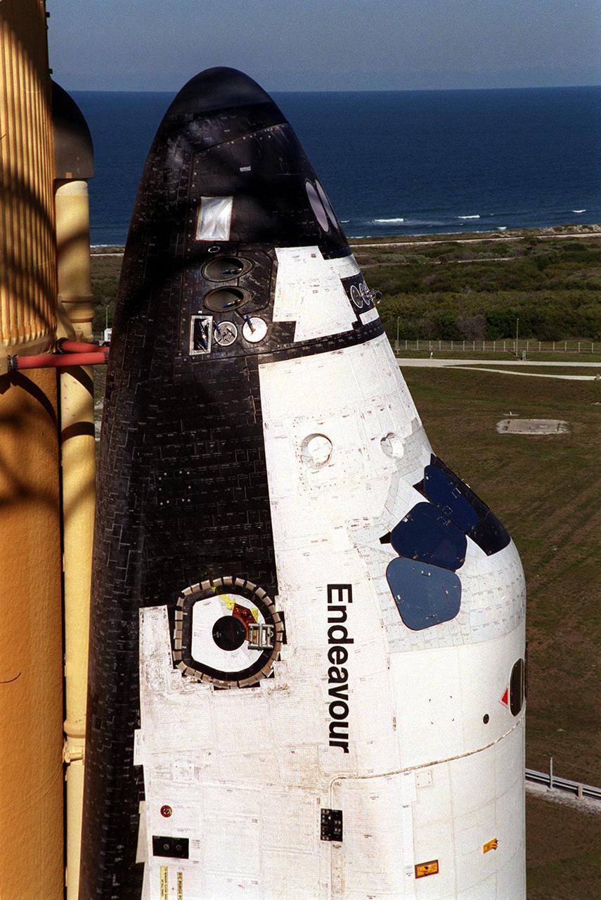KENNEDY SPACE CENTER, FLA. -- In this closeup of Space Shuttle Endeavour at Launch Pad 39A, the crew entry can be seen just to the left of the orbiter’s name. Prior to launch, the orbiter access arm with the White Room at the end will extend to the entry, enabling the crew to enter the orbiter. In the background, the Atlantic Ocean can be seen. Endeavour is expected to lift off on mission STS-100 on April 19, carrying the Multi-Purpose Logistics Module Raffaello and the Canadian robotic arm, SSRMS, to the International Space Station