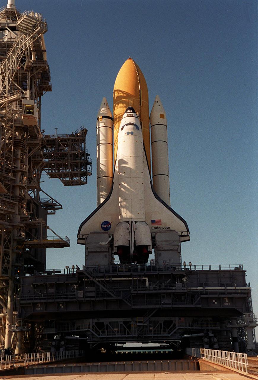 KENNEDY SPACE CENTER, FLA. -- The afternoon sun streaming through the Fixed Service Structure throws grid-like shadows over Space Shuttle Endeavour after arriving on Launch Pad 39A. In the background is seen the deep blue of the Atlantic Ocean. Endeavour is expected to lift off on mission STS-100 on April 19, carrying the Multi-Purpose Logistics Module Raffaello and the Canadian robotic arm, SSRMS, to the International Space Station
