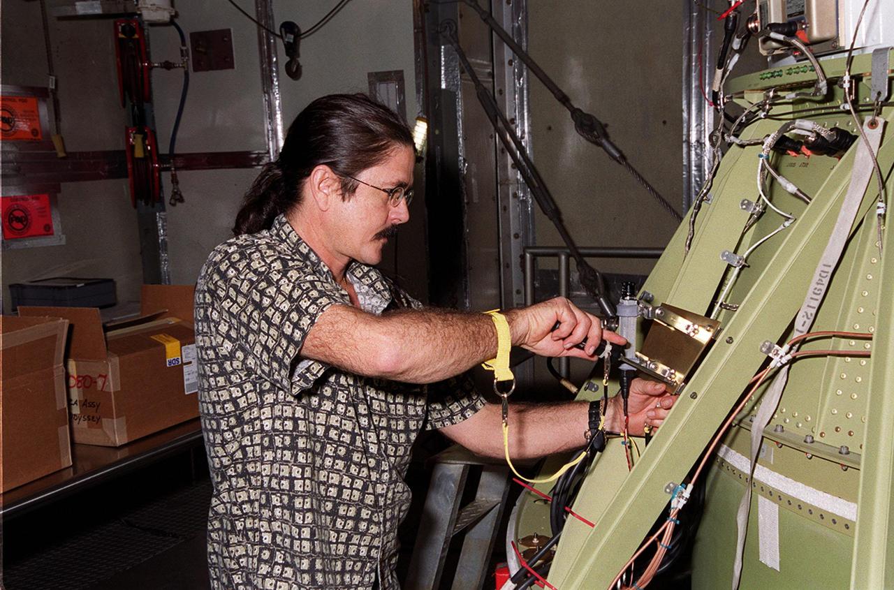 At Launch Pad 17-A, Cape Canaveral Air Force Station, a worker attaches a camera to the second stage of the Delta II rocket for the Mars Odyssey launch. The orbiter carries three science instruments THEMIS, the Gamma Ray Spectrometer (GRS), and the Mars Radiation Environment Experiment (MARIE) that will map the mineralogy and morphology of the Martian surface. The Mars Odyssey Orbiter is scheduled for launch on April 7, 2001