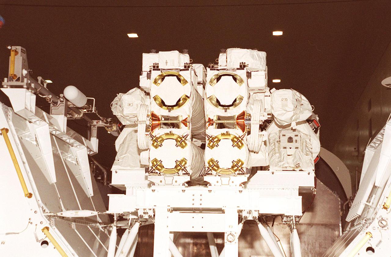 The Canadian robotic arm, SSRMS, and its pallet rest inside the payload canister in the Space Station Processing Facility. The arm is 57.7 feet (17.6 meters) long when fully extended and has seven motorized joints. It is capable of handling large payloads and assisting with docking the Space Shuttle. The SSRMS is self-relocatable with a Latching End Effector, so it can be attached to complementary ports spread throughout the Station’s exterior surfaces. The SSRMS is part of the payload on mission STS-100, scheduled to launch April 19 at 2:41 p.m. EDT from Launch Pad 39A, KSC