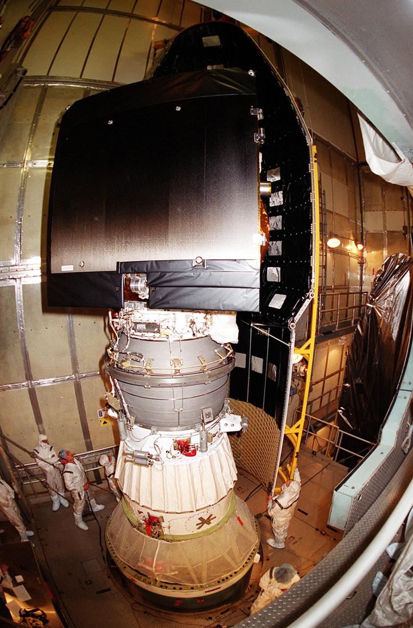 At Launch Complex 17-A, Cape Canaveral Air Force Station, a piece of the Delta rocket fairing moves closer to the Mars Odyssey spacecraft. NASA’s latest explorer carries three scientific instruments to map the chemical and mineralogical makeup of Mars: a thermal-emission imaging system, a gamma ray spectrometer and a Martian radiation environment experiment. The imaging system will map the planet with high-resolution thermal images and give scientists an increased level of detail to help them understand how the mineralogy of the planet relates to the land forms. In addition, Odyssey will serve as a communications relay for U.S. and international landers arriving at Mars in 2003_2004. The Mars Odyssey is scheduled for launch aboard a Delta II rocket April 7, 2001, at 11:02 a.m. EST