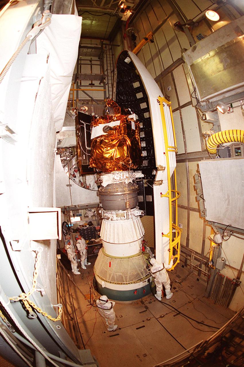 Workers at Launch Complex 17-A, Cape Canaveral Air Force Station, carefully maneuver the Delta rocket fairing as it closes in on the Mars Odyssey spacecraft. NASA’s latest explorer carries three scientific instruments to map the chemical and mineralogical makeup of Mars: a thermal-emission imaging system, a gamma ray spectrometer and a Martian radiation environment experiment. The imaging system will map the planet with high-resolution thermal images and give scientists an increased level of detail to help them understand how the mineralogy of the planet relates to the land forms. In addition, Odyssey will serve as a communications relay for U.S. and international landers arriving at Mars in 2003_2004. The Mars Odyssey is scheduled for launch aboard a Delta II rocket April 7, 2001, at 11:02 a.m. EST