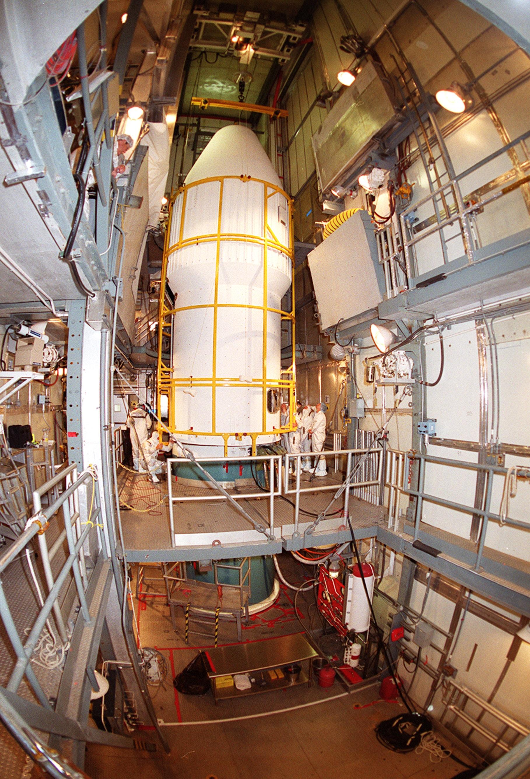 At Launch Complex 17-A, Cape Canaveral Air Force Station, the pristine white fairing comes together, enclosing the Mars Odyssey spacecraft inside. The Mars Odyssey is scheduled for launch aboard a Delta II rocket April 7, 2001, at 11:02 a.m. EST. NASA’s latest explorer carries three scientific instruments to map the chemical and mineralogical makeup of Mars: a thermal-emission imaging system, a gamma ray spectrometer and a Martian radiation environment experiment. The imaging system will map the planet with high-resolution thermal images and give scientists an increased level of detail to help them understand how the mineralogy of the planet relates to the land forms. In addition, Odyssey will serve as a communications relay for U.S. and international landers arriving at Mars in 2003_2004