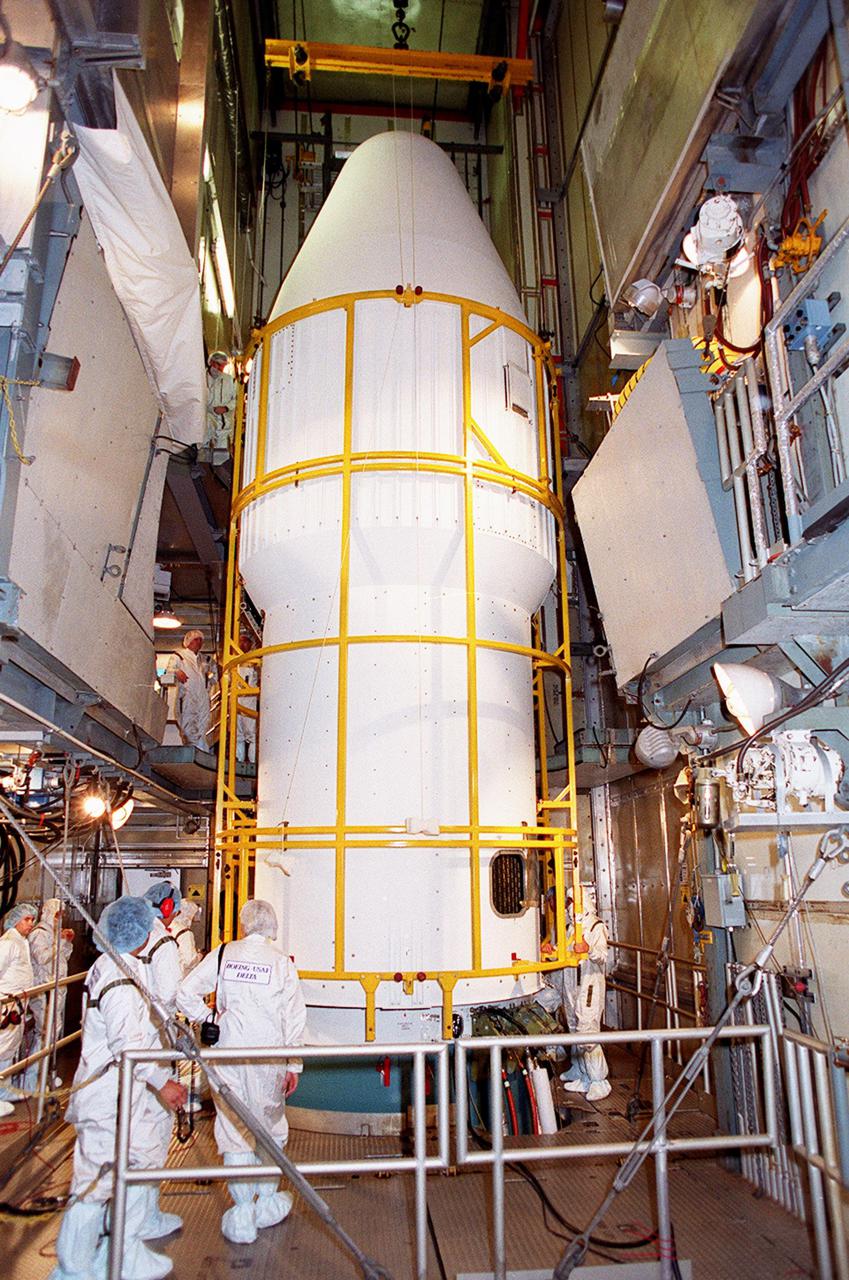 At Launch Complex 17-A, Cape Canaveral Air Force Station, workers check the fairing now enclosing the Mars Odyssey spacecraft inside. The Mars Odyssey is scheduled for launch aboard a Delta II rocket April 7, 2001, at 11:02 a.m. EST. NASA’s latest explorer carries three scientific instruments to map the chemical and mineralogical makeup of Mars: a thermal-emission imaging system, a gamma ray spectrometer and a Martian radiation environment experiment. The imaging system will map the planet with high-resolution thermal images and give scientists an increased level of detail to help them understand how the mineralogy of the planet relates to the land forms. In addition, Odyssey will serve as a communications relay for U.S. and international landers arriving at Mars in 2003_2004