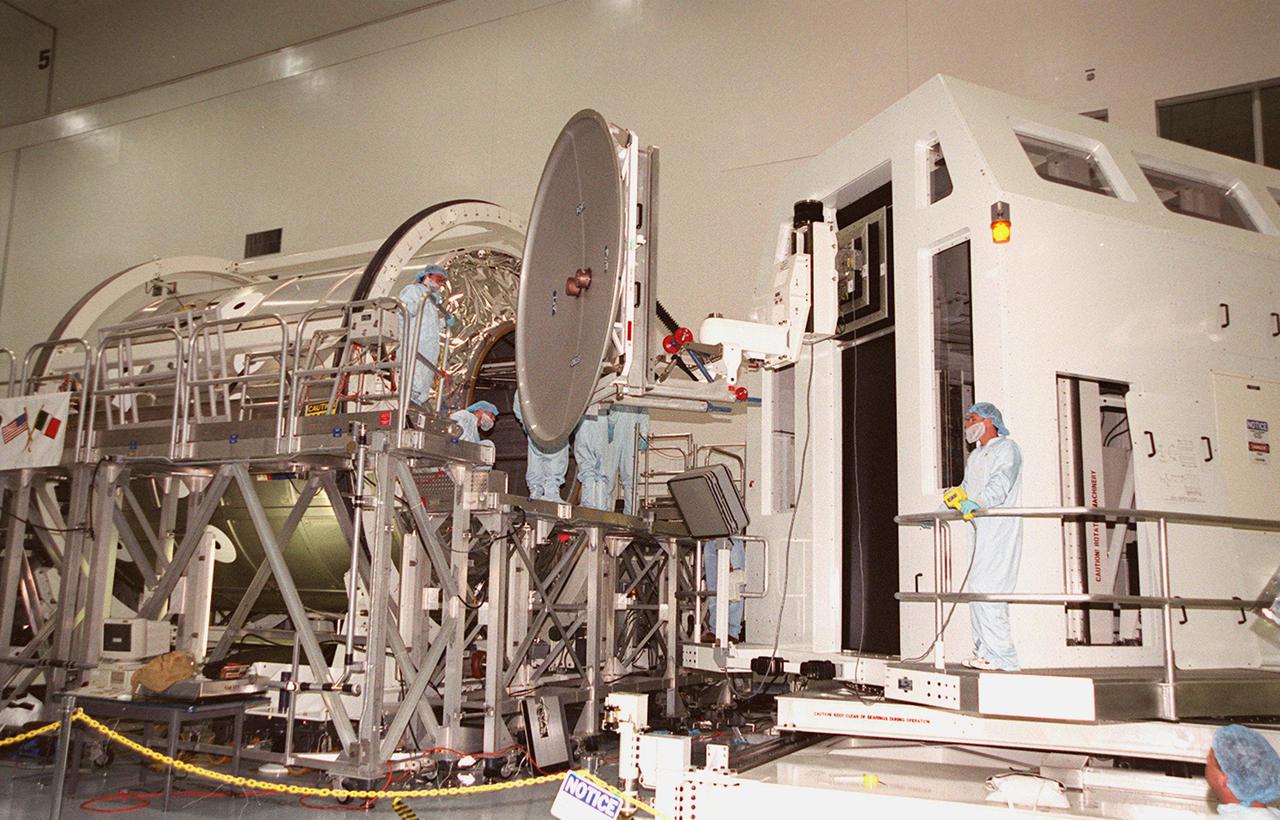 KENNEDY SPACE CENTER, FLA. -- The hatch on Multi-Purpose Logistics Module Leonardo is removed in the Space Station Processing Facility. The MPLM has just returned from its maiden voyage to the International Space Station aboard Discovery on mission STS-102. Leonardo is one of three MPLMs built by the Italian Space Agency to serve as “cargo vans” to the Station, carrying supplies and equipment. In the SSPF, Leonardo will be prepared for a future mission
