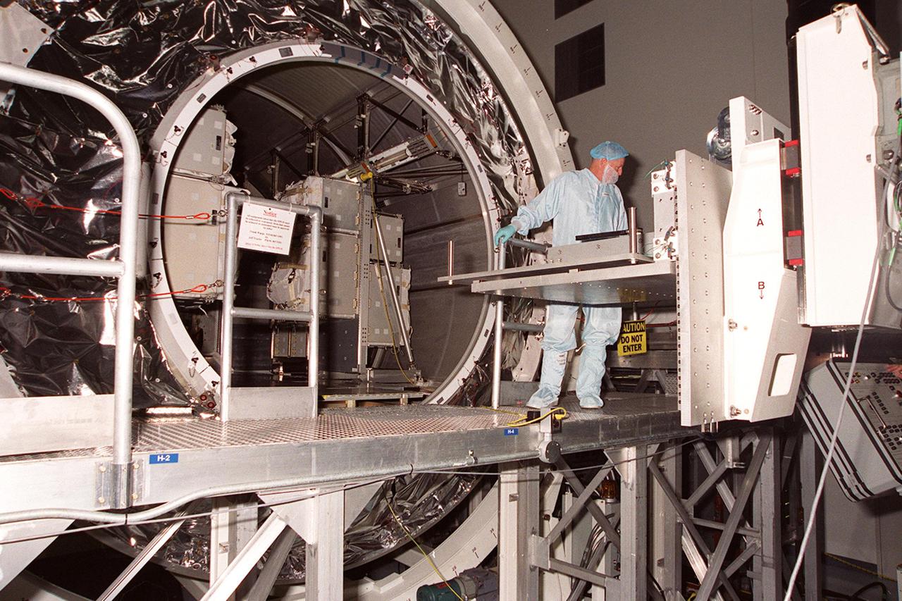 KENNEDY SPACE CENTER, FLA. -- With the hatch of Multi-Purpose Logistics Module Leonardo open, the contents are ready to be removed. The MPLM has just returned from its maiden voyage to the International Space Station aboard Discovery on mission STS-102. It has brought back to KSC nearly a ton of trash and excess equipment from the Space Station. Leonardo is one of three MPLMs built by the Italian Space Agency to serve as “cargo vans” to the Station, carrying supplies and equipment. In the SSPF, Leonardo will be prepared for a future mission