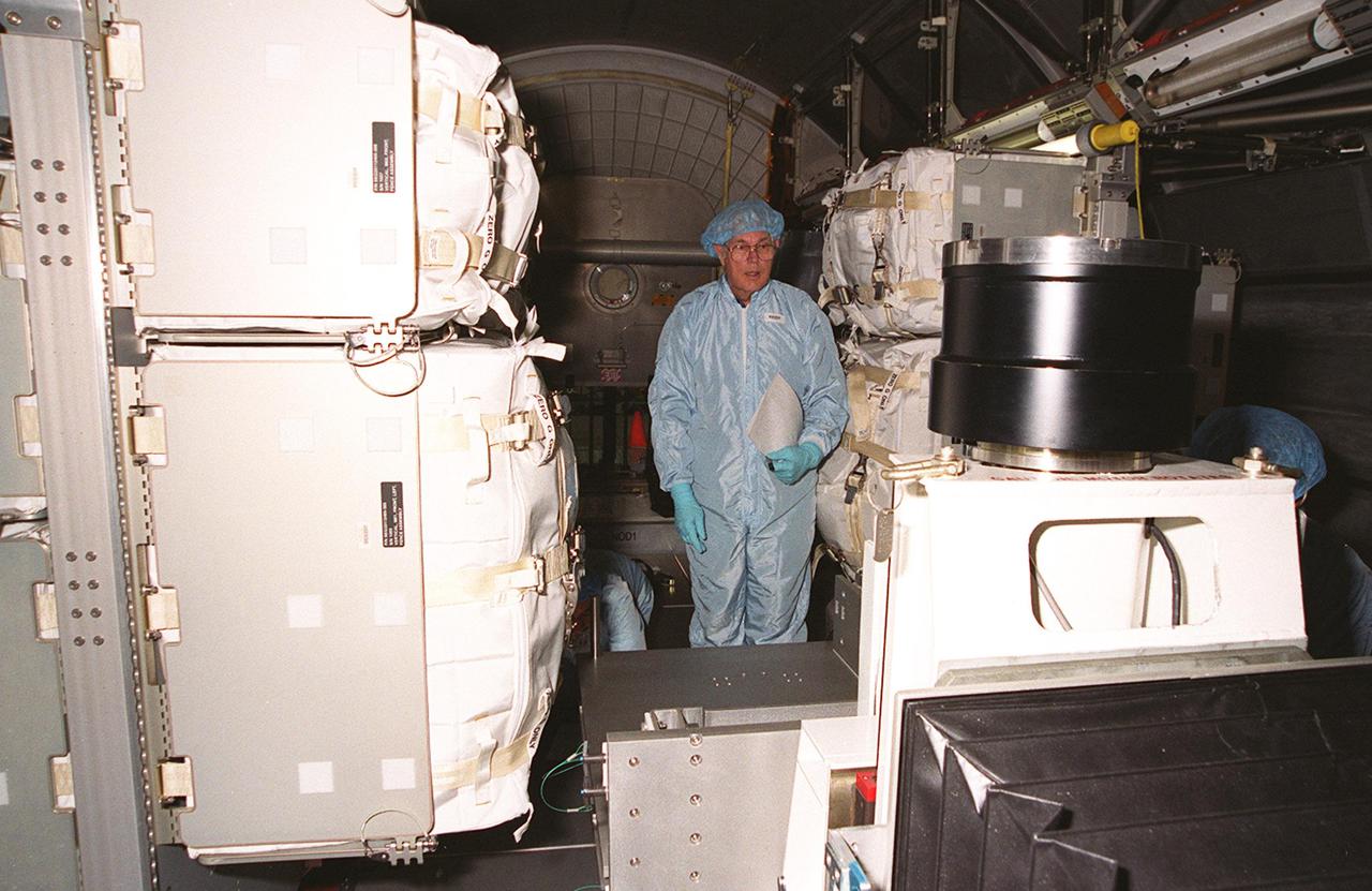 KENNEDY SPACE CENTER, FLA. -- Before removing the contents of the the Multi-Purpose Logistics Module Leonardo, which is in the Space Station Processing Facility, a worker takes inventory. The MPLM has just returned from its maiden voyage to the International Space Station aboard Discovery on mission STS-102. It has brought back to KSC nearly a ton of trash and excess equipment from the Space Station. Leonardo is one of three MPLMs built by the Italian Space Agency to serve as “cargo vans” to the Station, carrying supplies and equipment. In the SSPF, Leonardo will be prepared for a future mission