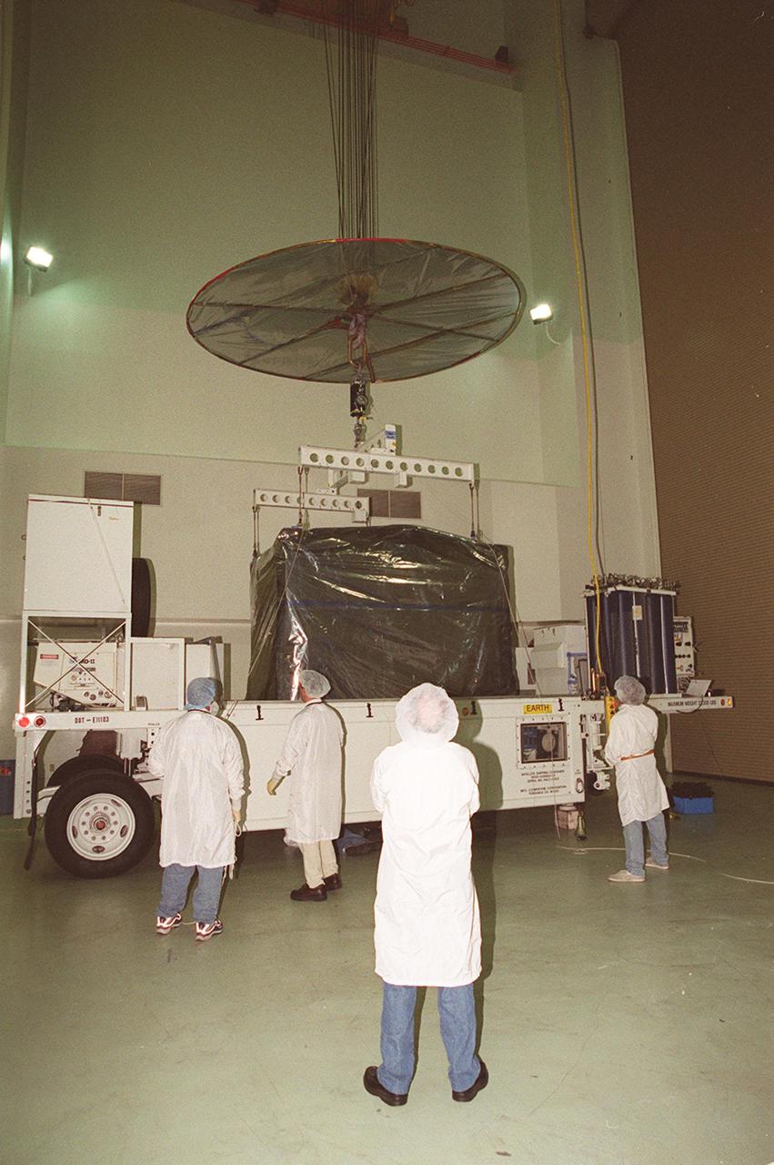 KENNEDY SPACE CENTER, FLA. -- After arrival at Astrotech, Titusville, Fla., the GOES-M (Geostationary Operational Environmental Satellite) is attached to an overhead crane. The GOES-M provides weather imagery and quantitative sounding data used to support weather forecasting, severe storm tracking and meteorological research. The satellite will undergo testing at Astrotech before its scheduled launch July 12 on an Atlas-IIA booster, Centaur upper stage from Cape Canaveral Air Force Station