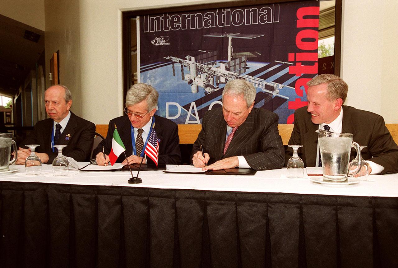 NASA Administrator Daniel S. Goldin and Italian Space Agency (ASI) President Sergio DeJulio sign a Framework for Cooperation to build the Habitation Module for the International Space Station. Seated at the table (left to right) are The Honorable Lamberto Dini, Minister of Foreign Affairs, Republic of Italy; DeJulio; Goldin; and John Schumacher, assistant administrator, External Relations, NASA. The Framework is a potential bilateral cooperative agreement that could result in ASI development of a U.S. Habitation Module for the International Space Station. This agreement allows the U.S. to explore an alternative approach to achieve full crew habitation for the ISS. A Memorandum of Understanding (MOU) between NASA and ASI will be required to formally document NASA and ASI’s respective responsibilities in a legally binding document. The Framework signed today would form the basis for a potential MOU which NASA and ASI would sign after completion of the program assessment and subsequent negotiations. The ceremony took place at the IMAX Theater, Kennedy Space Center Visitor Complex