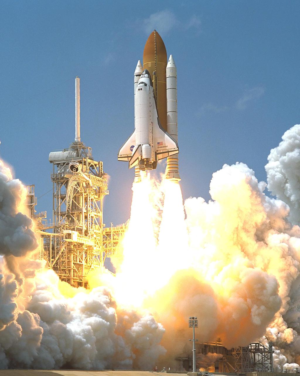 KENNEDY SPACE CENTER, FLA. -- Space Shuttle Endeavour races into space, springing forth from clouds of smoke and steam, on mission STS-100. Liftoff of the ninth flight to the International Space Station occurred at 2:40:42 p.m. EDT. The 11-day mission will deliver and integrate the Spacelab Logistics Pallet_Launch Deployment Assembly, which includes the Space Station Remote Manipulator System and the UHF Antenna. The mission includes two planned spacewalks for installation of the SSRMS on the Station. Also onboard is the Multi-Purpose Logistics Module Raffaello, carrying resupply stowage racks and resupply_return stowage platforms