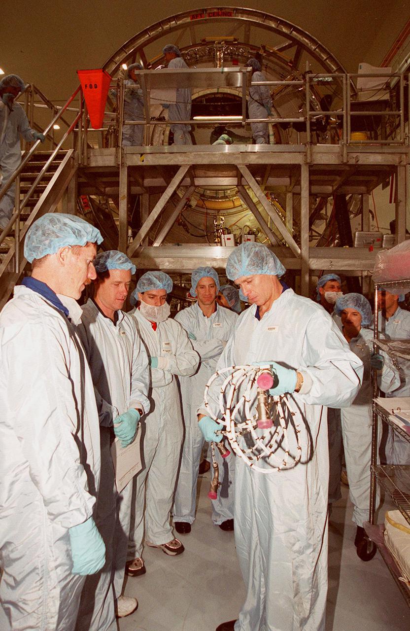 KENNEDY SPACE CENTER, FLA. -- Members of the STS-104 crew check out equipment at the Space Station Processing Facility as part of Crew Equipment Interface Test activities. Shown (from left) are Mission Specialist James F. Reilly II and Commander Steven W. Lindsey; (rear) Pilot Charles O. Hobaugh; (right) Mission Specialist Michael L. Gernhardt. Not shown is Mission Specialist Janet L. Kavandi. ). The mission will carry the Joint Airlock Module to the International Space Station. The U.S.-made module will allow astronauts and cosmonauts in residence on the Station to perform future spacewalks without the presence of a Space Shuttle. The module, which comprises a crew lock and an equipment lock, will be connected to the starboard (right) side of Node 1 Unity. Atlantis will also carry oxygen and nitrogen storage tanks, vital to operation of the Joint Airlock, on a Spacelab Logistics Double Pallet in the payload bay. The tanks, to be installed on the perimeter of the Joint Module during the mission’s spacewalks, will support future spacewalk operations and experiments plus augment the resupply system for the Station’s Service Module