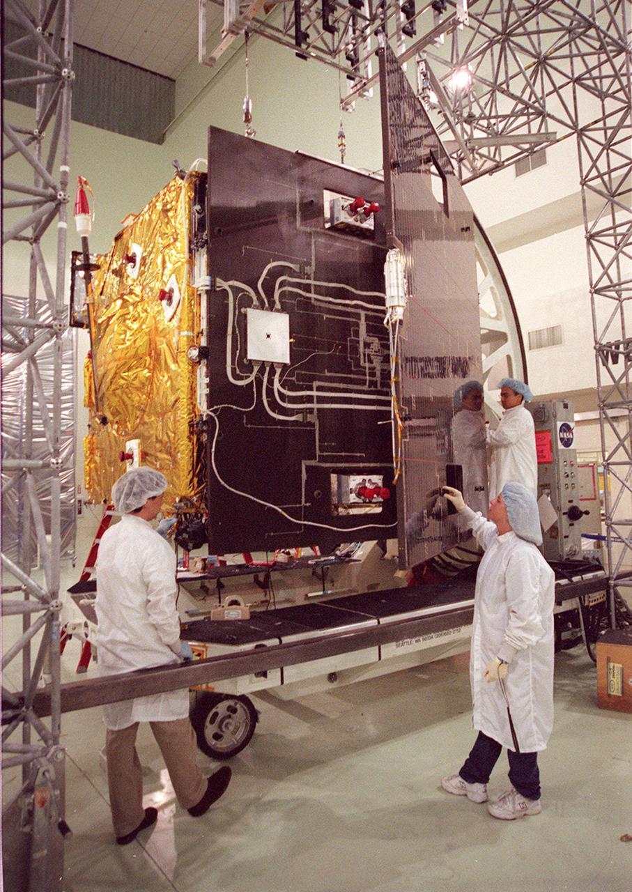 Workers at Astrotech, Titusville, Fla., open the solar panel on the GOES-M satellite. The GOES-M provides weather imagery and quantitative sounding data used to support weather forecasting, severe storm tracking and meteorological research. The satellite is scheduled to launch July 12 on an Atlas-IIA booster, Centaur upper stage from Cape Canaveral Air Force Station