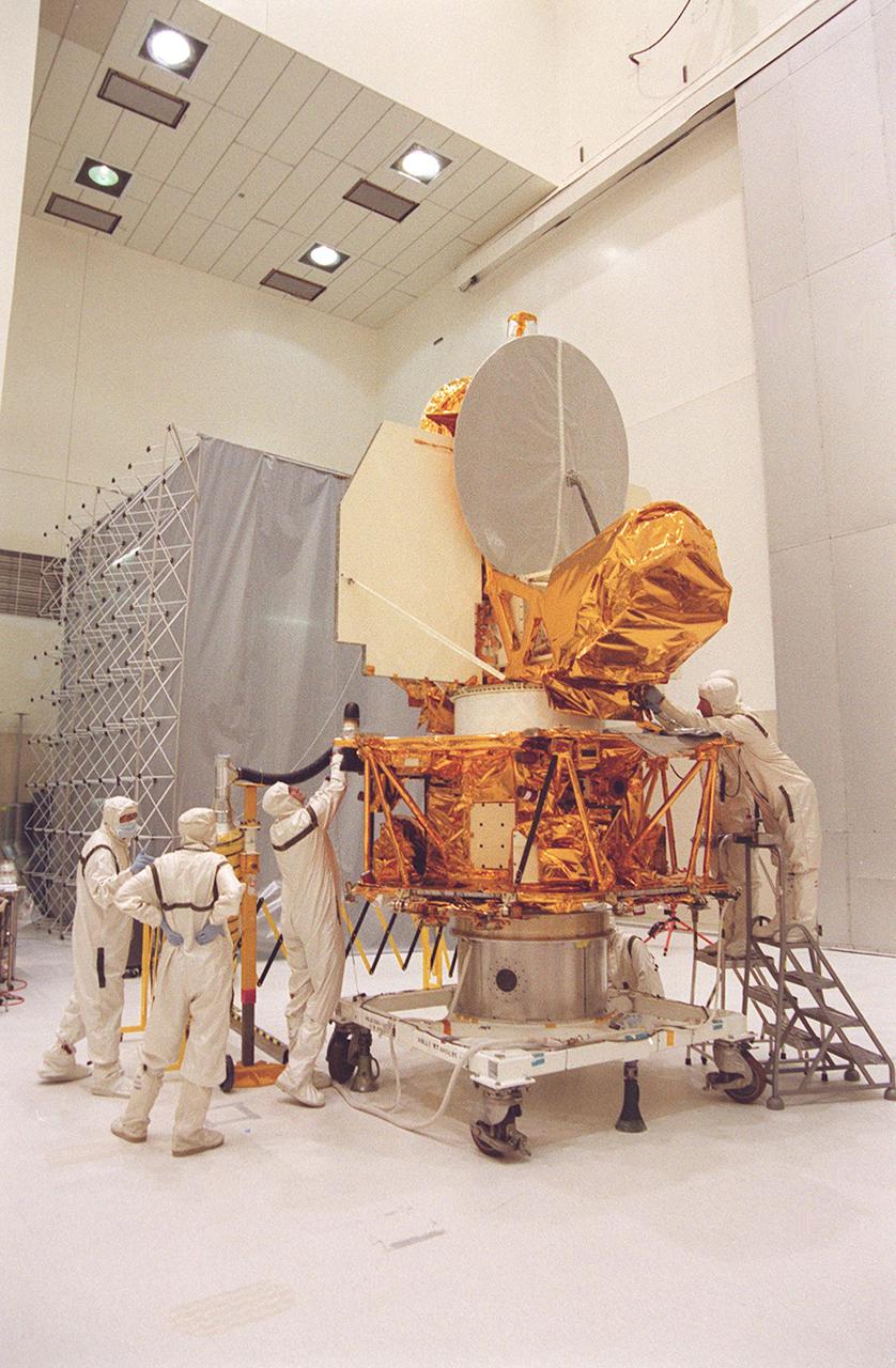 KENNEDY SPACE CENTER, FLA. -- In the Spacecraft Assembly and Encapsulation Facility 2, workers check out parts of the Microwave Anisotropy Probe (MAP. Several milestones must be completed while MAP is at SAEF-2, including antenna and solar array installation, solar array deployment and illumination testing, a spacecraft comprehensive performance test, fueling with hydrazine propellant and a spin balance test. MAP will then be ready for integration with the solid propellant Payload Assist Module upper stage booster. MAP is scheduled for launch June 30 from Cape Canaveral Air Force Station on a Delta II rocket into a lunar-assisted trajectory to the Sun-Earth for a 27-month mission. The MAP instrument consists of a set of passively cooled microwave radiometers with 1.4x 1.6-meter diameter primary reflectors to provide the desired angular resolution. MAP measures small fluctuations in the temperature of the cosmic microwave background radiation to an accuracy of one millionth of a degree These measurements should reveal the size, matter content, age, geometry and fate of the universe. They will also reveal the primordial structure that grew to form galaxies and will test ideas about the origins of these primordial structures. The MAP instrument will be continuously shaded from the Sun, Earth, and Moon by the spacecraft. It is a product of Goddard Space Flight Center in partnership with Princeton University