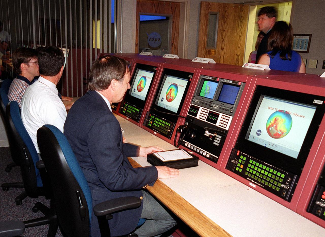 At the dedication of the upgraded Launch Vehicle Data Center in Hangar AE, Cape Canaveral Air Force Station, Fla., attendees got a close look at the new consoles. Seated on the right is Steve Francois, program manager, Expendable Vehicles and Payload Carriers. The new facility’s three individual control rooms replace a single LVDC control room in use since the mid-1970s. Developed by NASA-KSC to support multiple test operations in parallel or a single large launch operation, the new LVDC allows up to 100 launch vehicle engineers to monitor the voice, data and video systems that support the checkout and launch of an expendable vehicle