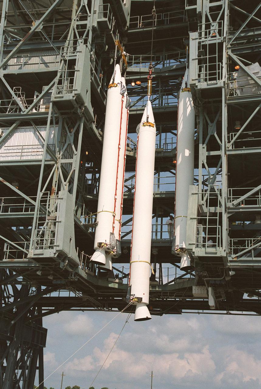 KENNEDY SPACE CENTER, FLA. --  Four solid rocket boosters are lifted up the gantry at Launch Complex 17-B, Cape Canaveral Air Force Station. The SRBs will be mated to the Delta II rocket that will launch the MAP instrument into a lunar-assisted trajectory to the Sun-Earth for a 27-month mission. The MAP mission will examine conditions in the early universe by measuring temperature differences in cosmic microwave background radiation, which is the radiant heat left over from the Big Bang. The properties of this radiation directly reflect conditions in the early universe. MAP is scheduled to launch June 30 at 3:46:46 p.m. EDT