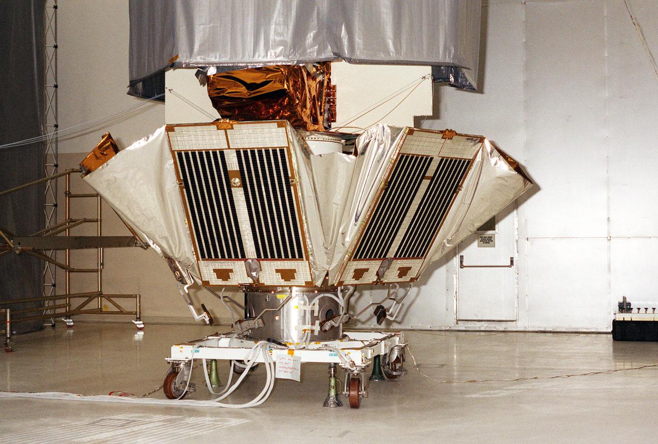 KENNEDY SPACE CENTER, FLA. -- Solar panels on the Microwave Anisotropy Probe (MAP) spacecraft begin deployment in the Spacecraft Assembly and Encapsulation Facility 2. MAP is scheduled for launch on June 30 aboard a Boeing Delta II rocket. The launch will place MAP into a lunar-assisted trajectory to the Sun-Earth for a 27-month mission. The probe will measure small fluctuations in the temperature of the cosmic microwave background radiation to an accuracy of one millionth of a degree. These measurements should reveal the size, matter content, age, geometry and fate of the universe. They will also reveal the primordial structure that grew to form galaxies and will test ideas about the origins of these primordial structures. The MAP instrument will be continuously shaded from the Sun, Earth, and Moon by the spacecraft. The probe is a product of Goddard Space Flight Center in partnership with Princeton University