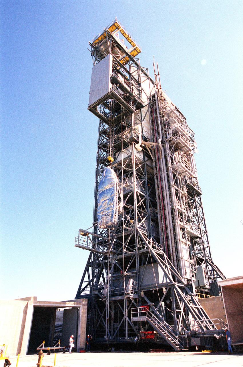 KENNEDY SPACE CENTER, FLA. -- On Complex 17-A, Cape Canaveral Air Force Station, the fairing for the Microwave Anisotropy Probe (MAP) spacecraft is lifted up the gantry to the White Room. There it will wait for the arrival of the spacecraft. MAP is scheduled for launch on June 30 aboard a Boeing Delta II rocket. The launch will place MAP into a lunar-assisted trajectory to the Sun-Earth for a 27-month mission. The probe will measure small fluctuations in the temperature of the cosmic microwave background radiation to an accuracy of one millionth of a degree. These measurements should reveal the size, matter content, age, geometry and fate of the universe. They will also reveal the primordial structure that grew to form galaxies and will test ideas about the origins of these primordial structures. The MAP instrument will be continuously shaded from the Sun, Earth, and Moon by the spacecraft. The probe is a product of Goddard Space Flight Center in partnership with Princeton University