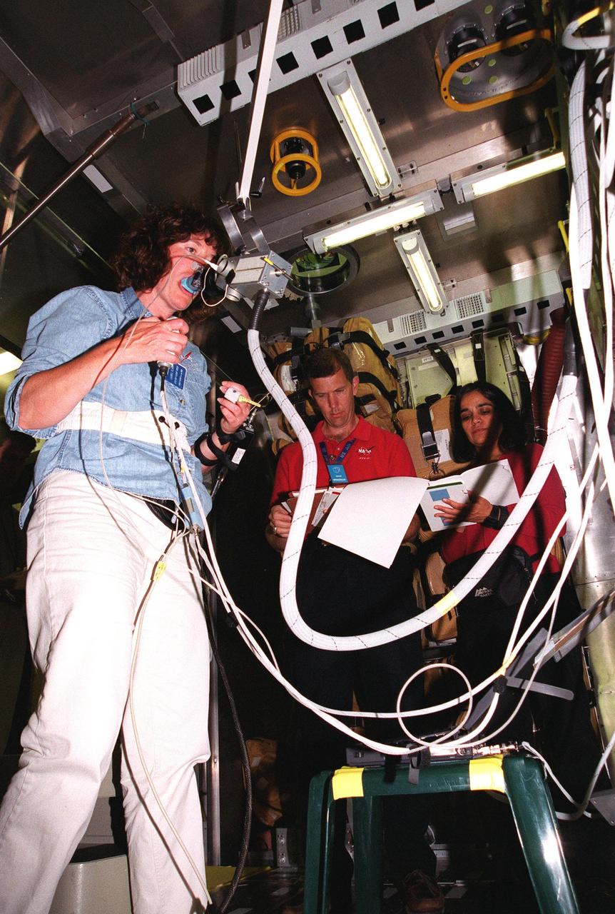 KENNEDY SPACE CENTER, Fla. -- At SPACEHAB, Cape Canaveral, Fla., Mission Specialist Laurel Blair Salton Clark practices an experiment while Commander Rick Douglas Husband and Mission Specialist Kalpana Chawla observe. They and other crew members Pilot William C. McCool; Payload Commander Michael P. Anderson; and Mission Specialists David M. Brown and Ilan Ramon, of Israel, are at SPACEHAB for Crew Equipment Interface Test (CEIT) activities. The CEIT enables the crew to perform certain flight operations, operate experiments in a flight-like environment, evaluate stowage locations and obtain additional exposure to specific experiment operations. As a research mission, STS-107 will carry the Spacehab Double Module in its first research flight into space and a broad collection of experiments ranging from material science to life science. STS-107 is scheduled for launch May 23, 2002