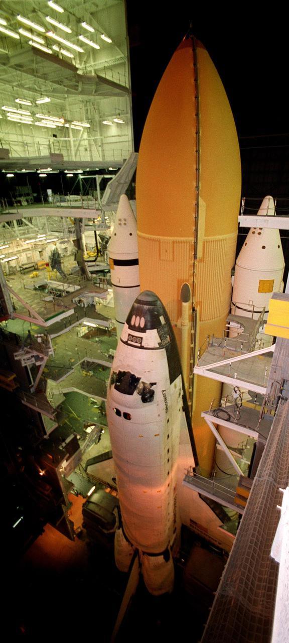 KENNEDY SPACE CENTER, Fla. -- Viewed from above, Space Shuttle Discovery, stacked with an orange external tank and white solid rocket boosters, waits in the Vehicle Assembly Building for rollout to Launch Pad 39A. Inclement weather has been a prime factor delaying the rollout. Discovery is scheduled for launch no earlier than Aug. 5 on mission STS-105, carrying the Expedition Three crew that will replace Expedition Two on the International Space Station
