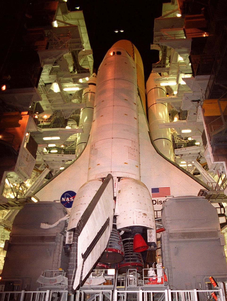 KENNEDY SPACE CENTER, Fla. -- Viewed from below, Space Shuttle Discovery nearly hides the orange external tank behind it. The twin solid rocket boosters can be seen on either side. Discovery waits in the Vehicle Assembly Building for rollout to Launch Pad 39A. Inclement weather has been a prime factor delaying the rollout. Discovery is scheduled for launch no earlier than Aug. 5 on mission STS-105, carrying the Expedition Three crew that will replace Expedition Two on the International Space Station