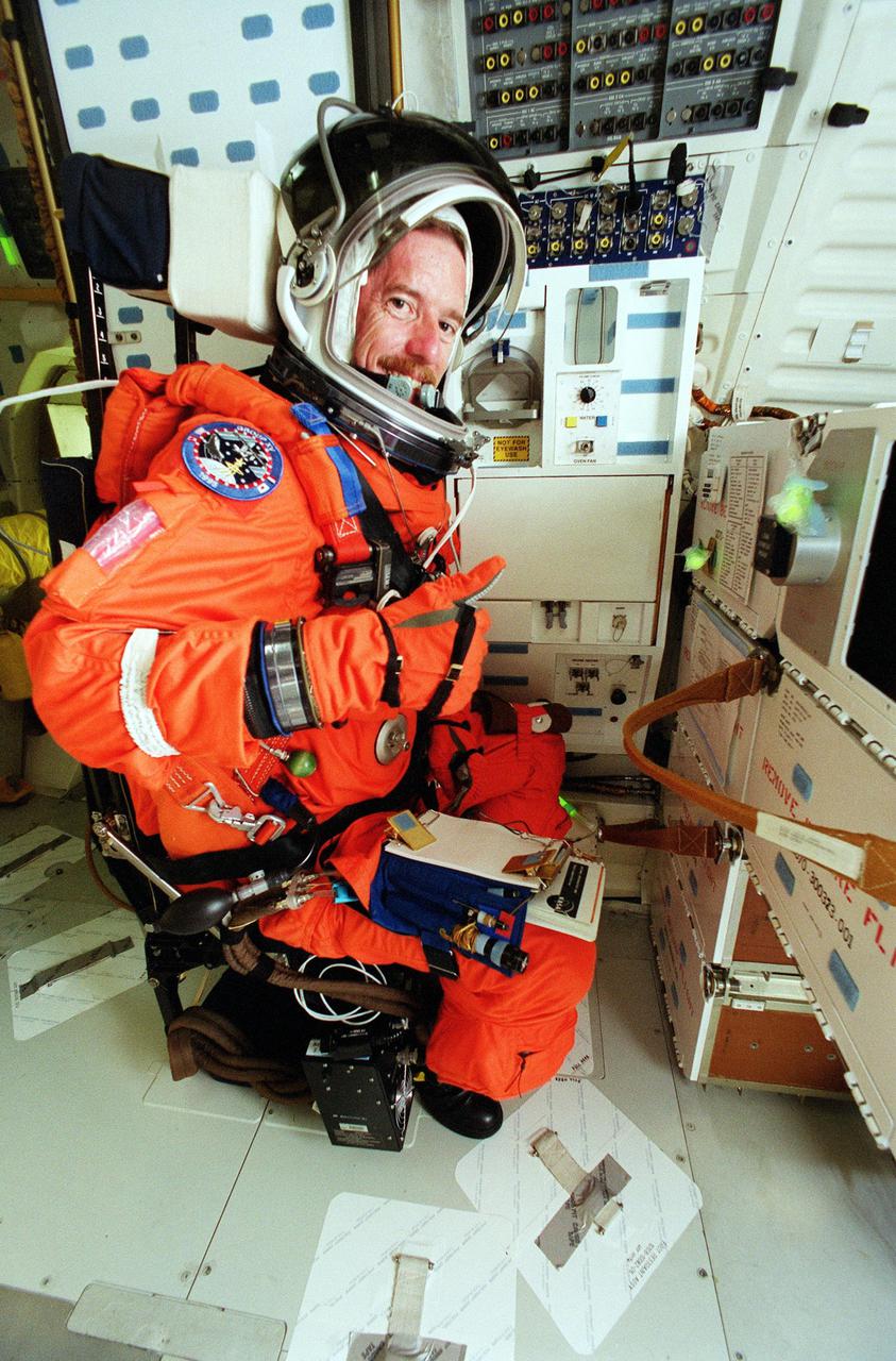 KENNEDY SPACE CENTER, Fla. -- STS-104 Mission Specialist James F. Reilly checks out equipment inside Atlantis. He and other crew members are taking part in a simulated countdown exercise, which is part of Terminal Countdown Demonstration Test activities. The launch of Atlantis on mission STS-104 is scheduled July 12. The mission is the 10th flight to the International Space Station and carries the Joint Airlock Module and High Pressure Gas Assembly