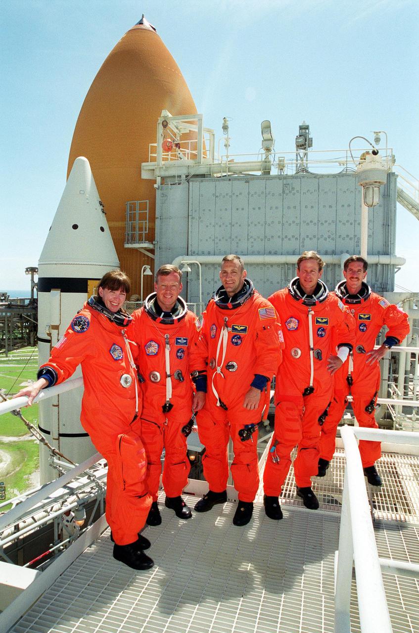 KENNEDY SPACE CENTER, Fla. -- The STS-104 crew poses for a group photo on the 215-foot level of the Fixed Service Structure. Standing left to right are Mission Specialist Janet Lynn Kavandi, Commander Steven Lindsey, Pilot Charles O. Hobaugh, and Mission Specialists Michael L. Gernhardt and James F. Reilly. The crew has been taking part in Terminal Countdown Demonstration Test activities, which include emergency egress training and a simulated countdown exercise. The launch of Atlantis on mission STS-104 is scheduled July 12. The mission is the 10th flight to the International Space Station and carries the Joint Airlock Module and High Pressure Gas Assembly