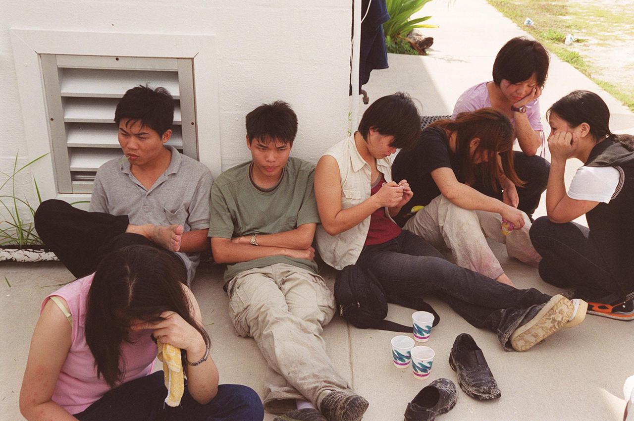 KENNEDY SPACE CENTER, Fla. -- Chinese foreign nationals, who arrived unannounced on Kennedy Space Center grounds, wait for representatives of Immigration and Naturalization Services to transport them to an office in Orlando for processing