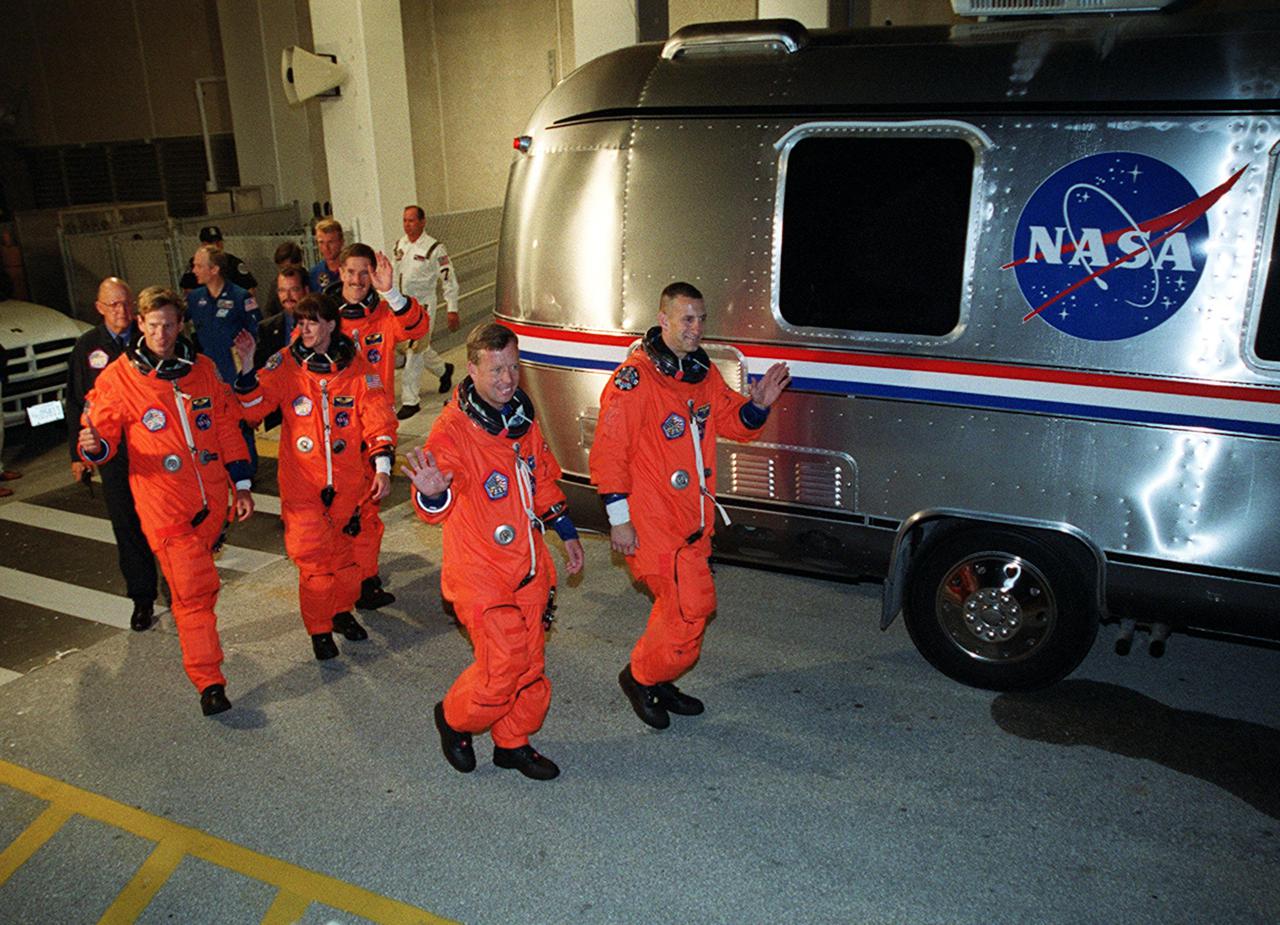 KENNEDY SPACE CENTER, Fla. -- The STS-104 crew heads for the Astrovan that will take them to Launch Pad 39B. Leading are Commander Steven W. Lindsey (left) and Pilot Charles O. Hobaugh. In the center is Mission Specialist Janet Lynn Kavandi. Following her are Mission Specialists Michael L. Gernhardt (left) and James F. Reilly. The launch of Space Shuttle Atlantis on mission STS-104 is targeted for 5:04 a.m., July 12, from Launch Pad 39B. The primary payload on the mission is the joint airlock module, which will be added to the International Space Station. The airlock will be the primary path for Space Station spacewalk entry and departure for U.S. spacesuits, and will also support the Russian Orlan spacesuit for EVA activity