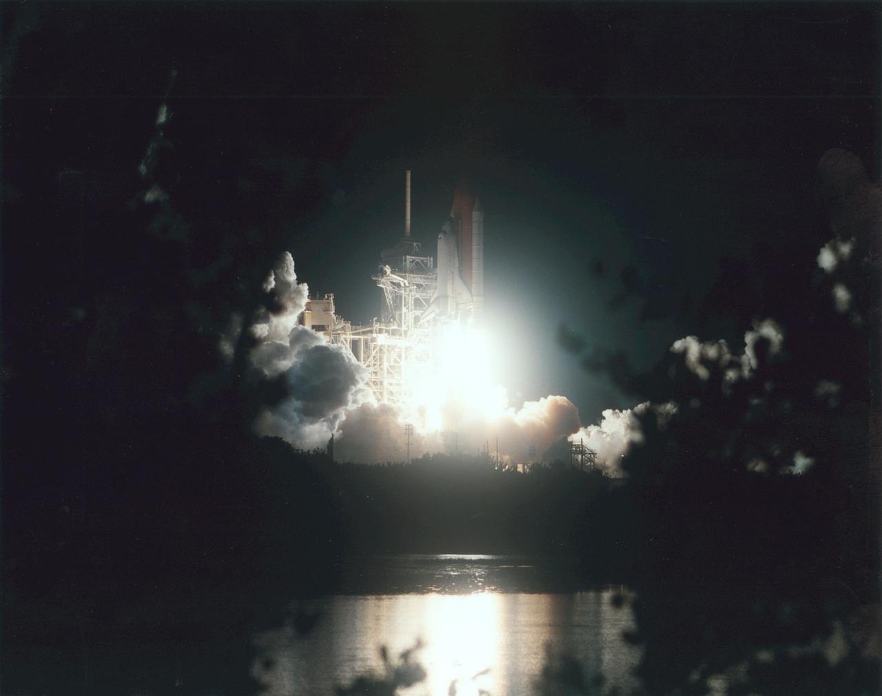 KENNEDY SPACE CENTER, Fla. -- Space Shuttle Atlantis lifts off in a blaze of light that spotlights it against the still-black sky and reflects in the nearby waters. Launch of Atlantis on mission STS-104 from Pad 39B was on time at 5:03:59 a.m. EDT. The 10th assembly flight to the International Space Station, the mission is delivering the joint airlock module, which will require two spacewalks to attach it to the Space Station. The airlock will be the primary path for Space Station spacewalk entry and departure for U.S. spacesuits, and will also support the Russian Orlan spacesuit for EVA activity