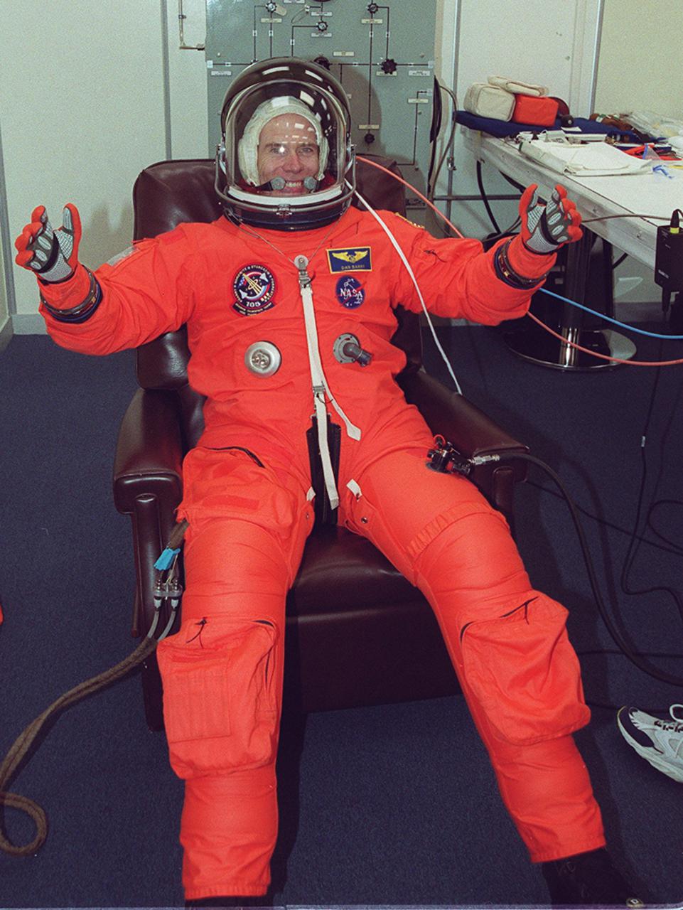 KENNEDY SPACE CENTER, Fla. -- STS-105 Mission Specialist Daniel Barry happily sits through suit fit check as part of Terminal Countdown Demonstration Test activities. He and other crew members Commander Scott Horowitz, Pilot Rick Sturckow and Mission Specialist Patrick Forrester are also taking part in the TCDT, which includes emergency egress training and a simulated launch countdown. Mission STS-105 will be transporting the Expedition Three crew - Commander Frank Culbertson and Vladimir Nikolaevich Dezhurov and Mikhail Tyurin, both with the Russian Aviation and Space Agency - several payloads and scientific experiments to the International Space Station aboard Space Shuttle Discovery. The current Expedition Two crew members on the Station will return to Earth on Discovery. Launch of Discovery is scheduled no earlier than Aug. 9, 2001