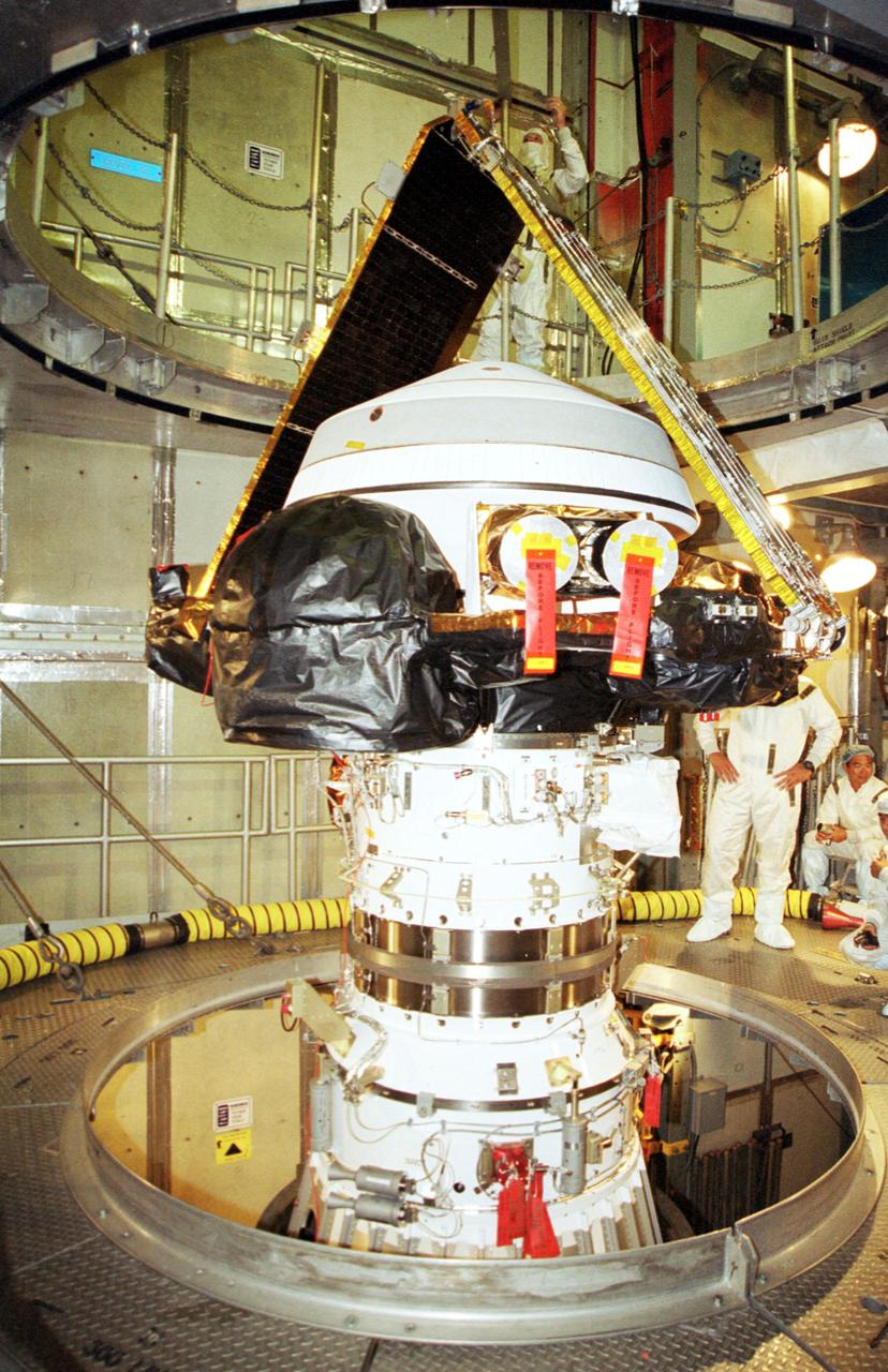 KENNEDY SPACE CENTER, Fla. -- After its canister has been removed, the Genesis spacecraft sits in place atop the Boeing Delta II rocket in the tower at Launch Complex 17-A, Cape Canaveral Air Force Station. Genesis will be on a robotic NASA space mission to catch a wisp of the raw material of the Sun and return it to Earth with a spectacular mid-air helicopter capture. The sample return capsule is 4.9 feet (1.5 meters) in diameter and 52 inches (1.31 meters) tall. The mission’s goal is to collect and return to Earth just 10 to 20 micrograms -- or the weight of a few grains of salt -- of solar wind, invisible charged particles that flow outward from the Sun. This treasured smidgen of the Sun will be preserved in a special laboratory for study by scientists over the next century in search of answers to fundamental questions about the exact composition of our star and the birth of our solar system. The Genesis launch is scheduled for 12:36 p.m. EDT on July 30 from CCAFS