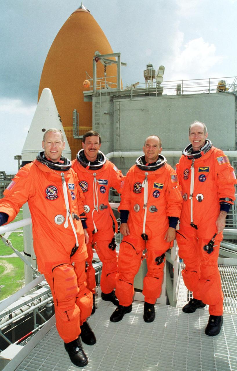 KENNEDY SPACE CENTER, Fla. -- The STS-105 crew poses on the Fixed Service Structure at Launch Pad 39A. From left are Mission Specialist Patrick Forrester, Commander Scott Horowitz, Pilot Rick Sturckow and Mission Specialist Dan Barry. The STS-105 and Expedition Three crews are at Kennedy Space Center participating in a Terminal Countdown Demonstration Test, a dress rehearsal for launch. The activities include emergency egress training, a simulated launch countdown and familiarization with the payload. Mission STS-105 will be transporting the Expedition Three crew, several payloads and scientific experiments to the International Space Station aboard Space Shuttle Discovery. The Expedition Two crew members currently on the Station will return to Earth on Discovery. The mission is scheduled to launch no earlier than Aug. 9, 2001