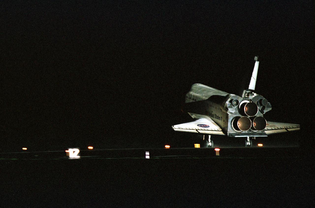 KENNEDY SPACE CENTER, Fla. -- Atlantis touches down on KSC’s Runway 15 as Atlantis completes a 12-day, 18-hour, 34-minute-long STS-104 mission. Main gear touchdown occurred at 11:38:55 p.m. EDT. At the controls is Commander Steven W. Lindsey. Other crew members on board are Pilot Charles Hobaugh and Mission Specialists Michael Gernhardt, Janet Lynn Kavandi and James F. Reilly. This is the 18th nighttime landing for a Space Shuttle, the 13th at Kennedy Space Center. The mission delivered the Joint Airlock Module to the International Space Station, which was subsequently attached to the Unity Node, completing the second phase of the assembly of the Space Station