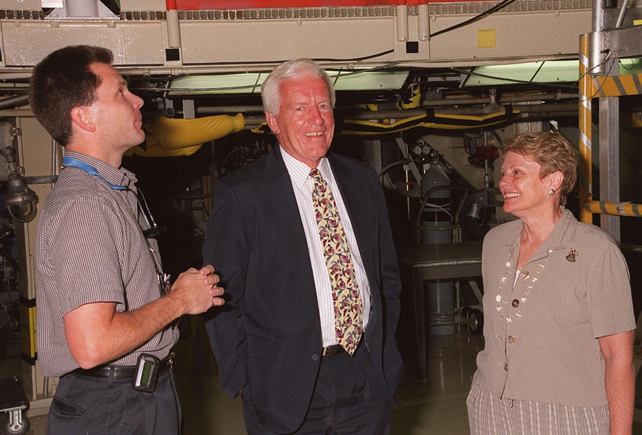 KENNEDY SPACE CENTER, FLA. -- The Undersecretary of the Air Force Dr. Lawrence Delaney (center) and his wife, Angie (right), are escorted around the Orbiter Processing Facility bay 3 by Scott Thurston (left). The orbiter Columbia is currently in bay 3 being prepared for mission STS-109. Targeted for launch in January 2002, STS-109 is a Hubble servicing mission.