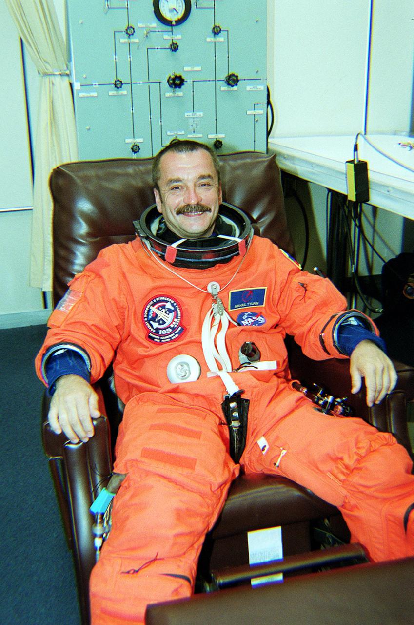 KENNEDY SPACE CENTER, Fla. -- Expedition Three cosmonaut Mikhail Tyurin suits up for launch on mission STS-105. The mission will be Tyurin’s first space flight. On the mission, Discovery will be transporting the Expedition Three crew and several scientific experiments and payloads to the International Space Station, including the Early Ammonia Servicer (EAS) tank. The EAS, which will support the thermal control subsystems until a permanent system is activated, will be attached to the Station during two spacewalks. The three-member Expedition Two crew will be returning to Earth aboard Discovery after a five-month stay on the Station. Launch is scheduled for 5:38 p.m. EDT Aug. 9