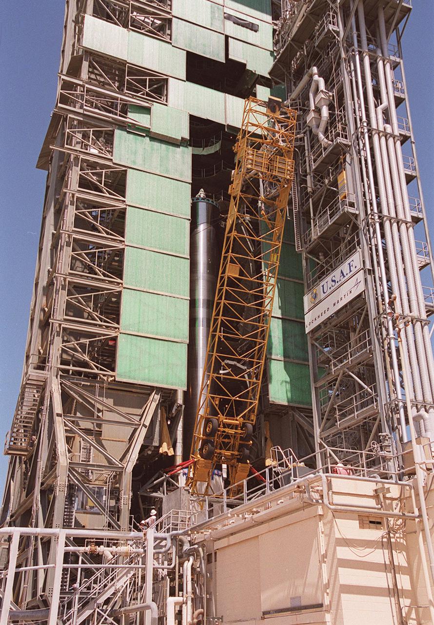 KENNEDY SPACE CENTER, Fla. - At Pad 36-A, Cape Canaveral Air Force Station, the equipment used to raise the Atlas II first (booster) stage into the launch tower is removed. The Atlas II will later be mated with the Tracking and Data Relay Satellite, known as TDRS-I, for launch in January 2002. The TDRS System (TDRSS) is a communication signal relay system that provides tracking and data acquisition services between low-Earth orbiting spacecraft and NASA_customer control and_or data processing facilities. The system is capable of transmitting to and receiving data from customer spacecrafts over 100 percent of their orbit (some limitations may apply depending on actual orbit). The TDRS-I provides a Ka-band service that will allow customers with extremely high data rates to be supported by the Tracking and Data Relay Satellite System (TDRSS) if they desire