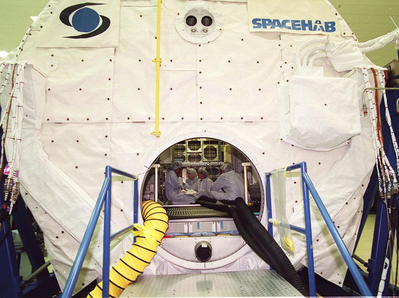 KENNEDY SPACE CENTER, Fla. -- At SPACEHAB,Cape Canaveral, the SPACEHAB Double Module is the site for equipment familiarization for some STS-107 crew members inside. The crew comprises Commander Rick Husband, Pilot William McCool, Payload Commander Michael Anderson, Mission Specialists Kalpana Chawla, David Brown and Laurel Clark, and Payload Specialist Ilan Ramon. STS-107 has two payload elements, the Double Module in its first flight into space and a Hitchhiker payload. The double module provides greater experiment capability than on previous flights, resulting for this mission in a very broad collection of experiments for NASA and commercial and European customers. The experiments range from material sciences to life sciences (many rats). The Hitchhiker carrier system is modular and expandable in accordance with payload requirements, which allows maximum efficiency in utilizing orbiter resources and increases the potential for early manifesting on the Shuttle. Hitchhiker experiments are housed in canisters or attached to mounting plates. The Hitchhiker canister comes in two varieties--the Hitchhiker Motorized Door Canister and the Sealed Canisters. STS-107 is scheduled to launch in May 2002