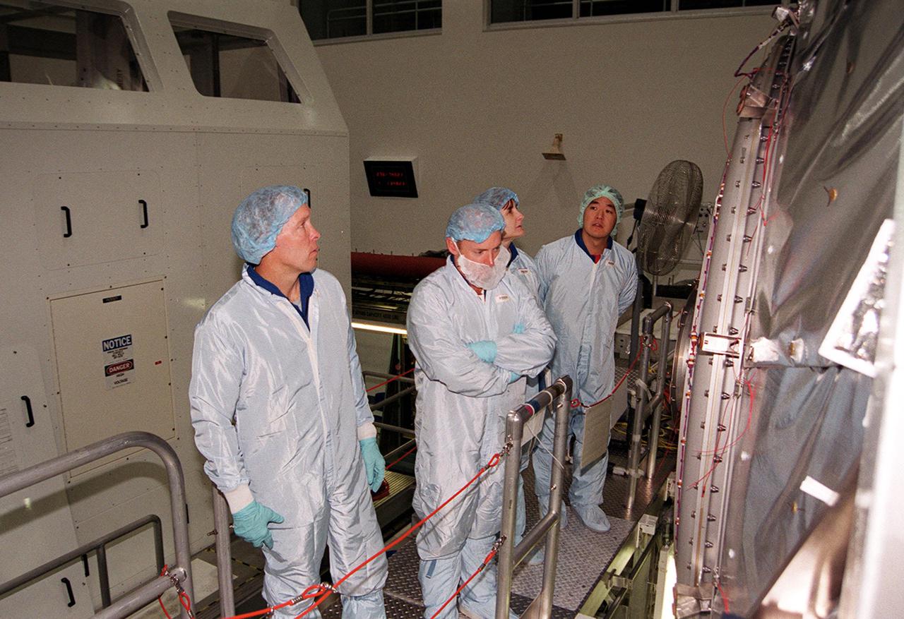 KENNEDY SPACE CENTER, Fla. -- The STS-108 crew look into the hatch of the Multi-Purpose Logistics Module Raffaello.  From left are Commander Dominic L. Gorie, Pilot Mark E. Kelly, and Mission Specialists Linda A. Godwin and Daniel M. Tani.  The four astronauts are taking part in Crew Equipment Interface Test (CEIT) activities at KSC. The CEIT provides familiarization with the launch vehicle and payload.  Mission STS-108 is a Utilization Flight (UF-1), carrying the Expedition Four crew plus Multi-Purpose Logistics Module Raffaello to the International Space Station.  The Expedition Four crew comprises Yuri Onufriyenko, commander, Russian Aviation and Space Agency, and astronauts Daniel W. Bursch and Carl E. Walz. Endeavour is scheduled to launch Nov. 29 on mission STS-108