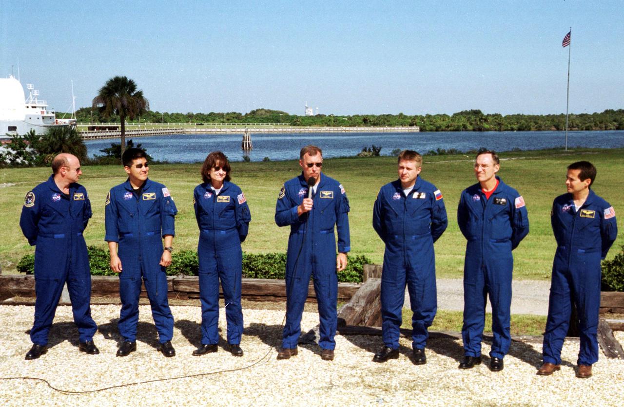KENNEDY SPACE CENTER, Fla. --  The STS-108 crew and Expedition 4 crew answer questions from the media during an interview session.  With the microphone is Commander Dominic L. Gorie.  From left are STS-108 Pilot Mark E. Kelly, Mission Specialists Daniel M. Tani and Linda A. Godwin, and Gorie; Expedition 4 Commander Yuri Onufrienko, Carl E. Walz and Daniel W. Bursch.  The crews are at KSC for Terminal Countdown Demonstration Test activities that include emergency exit training from the orbiter and launch pad and a simulated launch countdown.  STS-108 is a Utilization Flight that will carry the replacement Expedition 4 crew to the International Space Station, as well as the Multi-Purpose Logistics Module Raffaello, filled with supplies and equipment.  The l1-day mission is scheduled for launch Nov. 29 on Space Shuttle Endeavour
