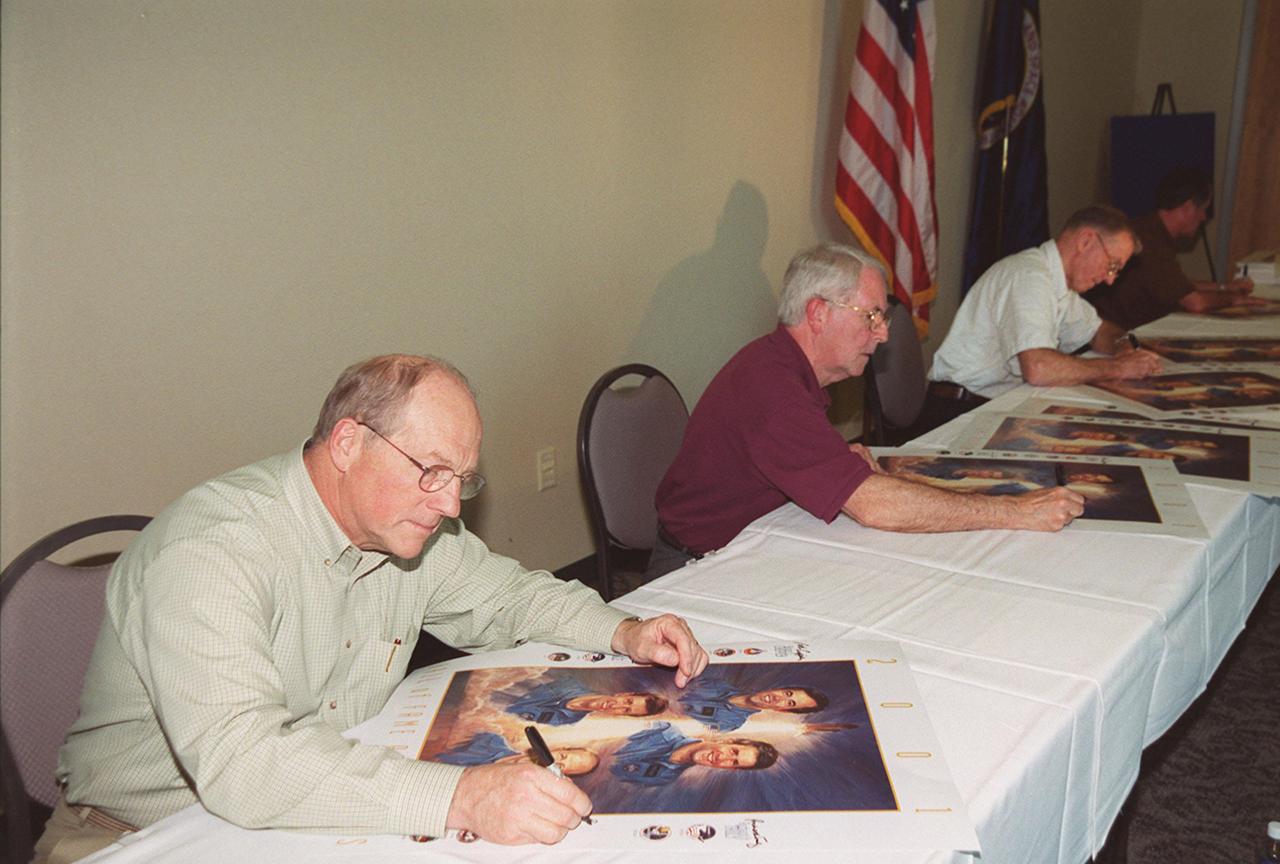 KENNEDY SPACE CENTER, Fla. -- The first four Shuttle astronauts take time to sign posters commemorating their induction into the U.S. Astronaut Hall of Fame Nov. 10. Seated from left are Frederick 'Rick' Hauck, Richard Truly, Joe Engle and Robert Crippen. The event took place at the KSC Visitor Complex