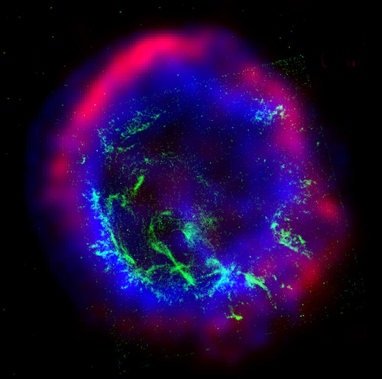 This image is a color composite of the supernova remnant E0102-72: x-ray (blue), optical (green), and radio (red). E0102-72 is the remnant of a star that exploded in a nearby galaxy known as the Small Magellanic Cloud. The star exploded outward at speeds in excess of 20 million kilometers per hour (12 million mph) and collided with surrounding gas. This collision produced two shock waves, or cosmic sonic booms, one traveling outward, and the other rebounding back into the material ejected by the explosion. The radio image, shown in red, was made using the Australia Telescope Compact Array. The radio waves are due to extremely high-energy electrons spiraling around magnetic field lines in the gas and trace the outward moving shock wave. The Chandra X-ray Observatory image, shown in blue, shows gas that has been heated to millions of degrees by the rebounding, or reverse shock wave. The x-ray data show that this gas is rich in oxygen and neon. These elements were created by nuclear reactions inside the star and hurled into space by the supernova. The Hubble Space Telescope optical image, shown in green, shows dense clumps of oxygen gas that have "cooled" to about 30,000 degrees. Photo Credit: X-ray (NASA/CXC/SAO); optical (NASA/HST): radio: (ACTA)