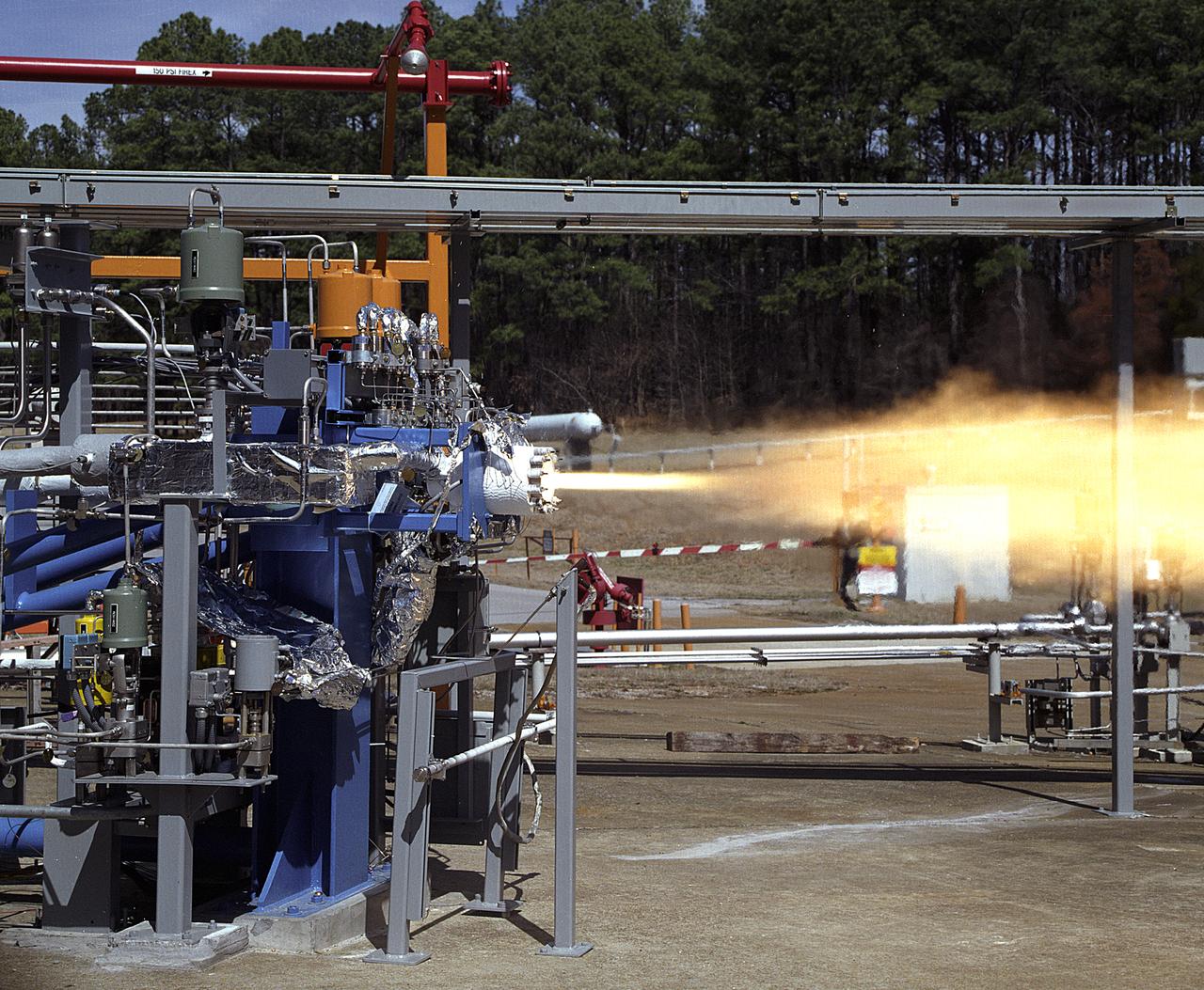 NASA's Marshall Space Flight Center (MSFC) in Huntsville, Alabama, has begun a series of engine tests on the Reaction Control Engine developed by TRW Space and Electronics for NASA's Space Launch Initiative (SLI). SLI is a technology development effort aimed at improving the safety, reliability, and cost effectiveness of space travel for reusable launch vehicles. The engine in this photo, the first engine tested at MSFC that includes SLI technology, was tested for two seconds at a chamber pressure of 185 pounds per square inch absolute (psia). Propellants used were liquid oxygen as an oxidizer and liquid hydrogen as fuel. Designed to maneuver vehicles in orbit, the engine is used as an auxiliary propulsion system for docking, reentry, fine-pointing, and orbit transfer while the vehicle is in orbit. The Reaction Control Engine has two unique features. It uses nontoxic chemicals as propellants, which creates a safer environment with less maintenance and quicker turnaround time between missions, and it operates in dual thrust modes, combining two engine functions into one engine. The engine operates at both 25 and 1,000 pounds of force, reducing overall propulsion weight and allowing vehicles to easily maneuver in space. The force of low level thrust allows the vehicle to fine-point maneuver and dock, while the force of the high level thrust is used for reentry, orbital transfer, and course positioning.