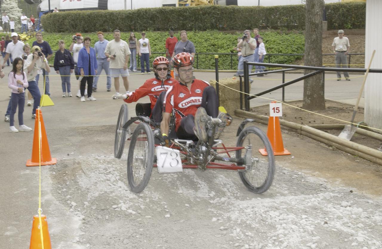 Students from across the United States and as far away as Puerto Rico and South America came to Huntsville, Alabama for the 9th annual Great Moonbuggy Race at the U.S. Space Rocket Center. Seventy-seven teams, representing high schools and colleges from 21 states, Puerto Rico, and Columbia, raced human powered vehicles over a lunar-like terrain. A team from Cornell University in Ithaca, New York, took the first place honor in the college division. This photograph shows the Cornell #2 team driving their vehicle through the course. The team finished the race in second place in the college division. Vehicles powered by two team members, one male and one female, raced one at a time over a half-mile obstacle course of simulated moonscape terrain. The competition is inspired by development, some 30 years ago, of the Lunar Roving Vehicle (LRV), a program managed by the Marshall Space Flight Center. The LRV team had to design a compact, lightweight, all-terrain vehicle, that could be transported to the Moon in the small Apollo spacecraft. The Great Moonbuggy Race challenges students to design and build a human powered vehicle so they will learn how to deal with real-world engineering problems, similar to those faced by the actual NASA LRV team.