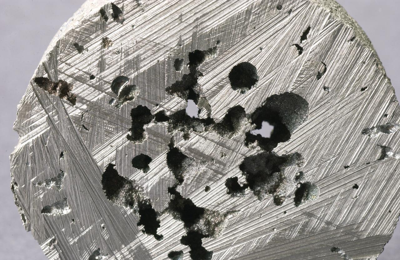 Pores and voids often form in metal castings on Earth (above) making them useless. A transparent material that behaves at a large scale in microgravity the way that metals behave at the microscopic scale on Earth, will help show how voids form and learn how to prevent them. Scientists are using the microgravity environment on the International Space Station to study how these bubbles form, move and interact. The Pore Formation and Mobility Investigation (PFMI) in the Microgravity Science Glovebox aboard the International Space Station uses a transparent material called succinonitrile that behaves like a metal to study this problem. Video images sent to the ground allow scientists to watch the behavior of the bubbles as they control the melting and freezing of the material. The bubbles do not float to the top of the material in microgravity, so they can study their interactions.