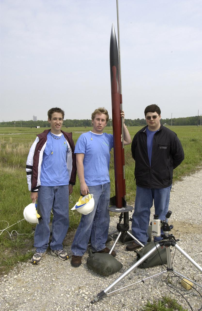 Filled with anticipation, students from three Huntsville area high schools: Randolph, Sparkman, and Johnson High Schools, counted down to launch the rockets they designed and built at the Army test site on Redstone Arsenal in Huntsville, Alabama. The projected two-mile high launch culminated more than a year's work and demonstrated the student team's ability to meet the challenge set by the Marshall Space Flight Center's (MSFC) Student Launch Initiative (SLI) program to apply science and math to experience, judgment, and common sense, and proved to NASA officials that they have successfully built reusable launch vehicles (RLVs), another challenge set by NASA's SLI program. MSFC's SLI program is an educational effort that aims to motivate students to pursue careers in science, math, and engineering. It provides them with hands-on, practical aerospace experience. In this picture, three Sparkman High School students pose with their rocket.