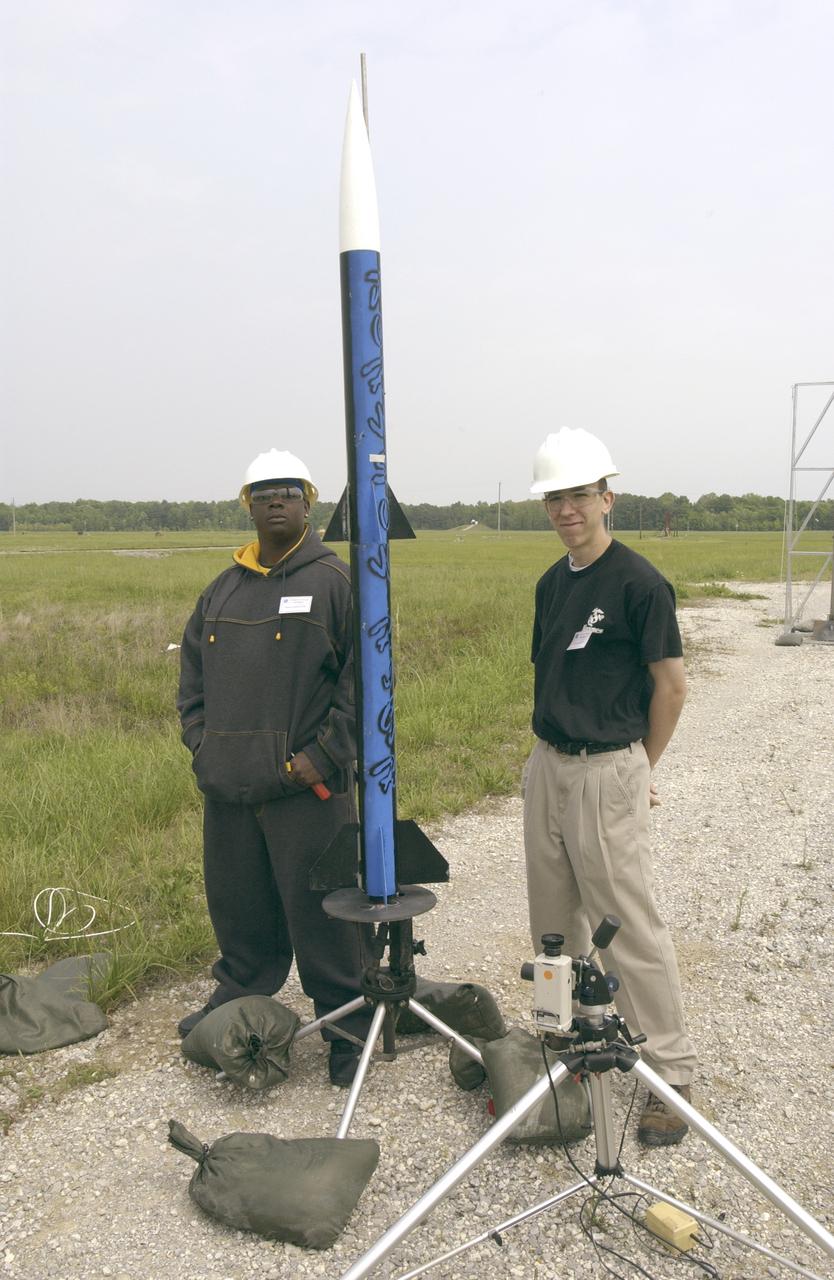 Filled with anticipation, students from three Huntsville area high schools: Randolph, Sparkman and Johnson High Schools, counted down to launch the rockets they designed and built at the Army test site on Redstone Arsenal in Huntsville, Alabama. The projected two-mile high launch culminated more than a year's work and demonstrated the student team's ability to meet the challenge set by the Marshall Space Flight Center's (MSFC) Student Launch Initiative (SLI) program to apply science and math to experience, judgment, and common sense, and proved to NASA officials that they have successfully built reusable launch vehicles (RLVs), another challenge set by NASA's SLI program. MSFC's SLI program is an educational effort that aims to motivate students to pursue careers in science, math, and engineering. It provides them with hands-on, practical aerospace experience. In this picture, two Johnson High School students pose with their rocket.